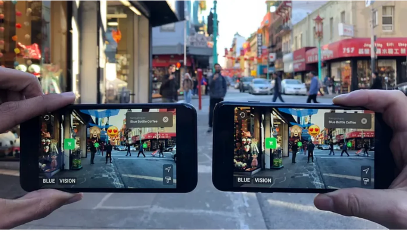 Blue Vision Labs shared AR demo with two phones seeing the same augmented content on a city street